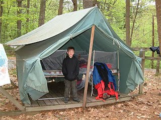 Camping kid beneath camping tent